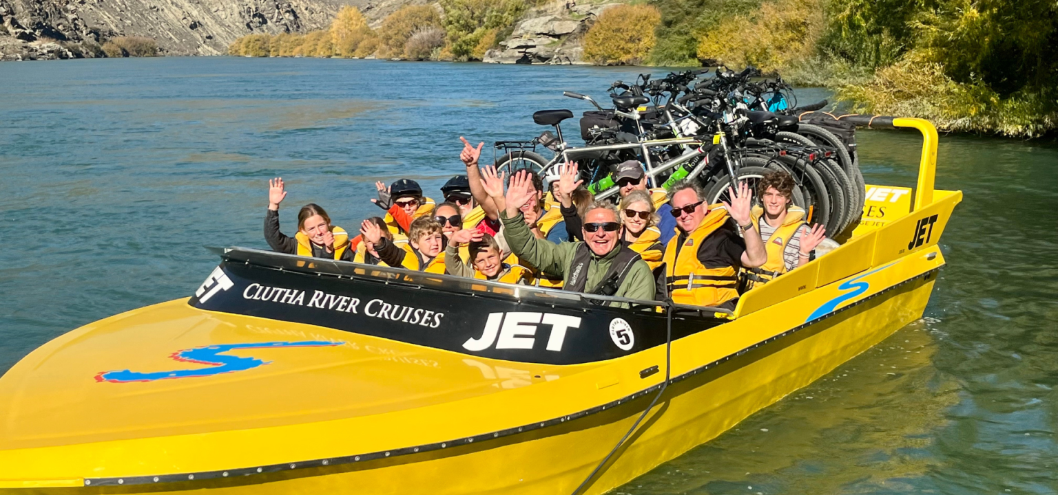 Clutha River Cruises jet boat along Clutha River near Clyde Dam